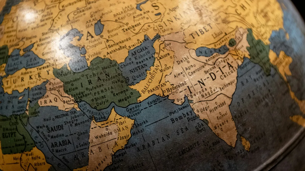 A close-up view of a globe, with the Indian subcontinent and surrounding regions prominently displayed.