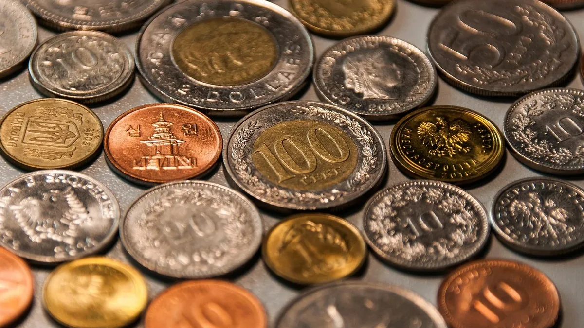 A collection of coins from various countries, featuring different denominations and currencies.