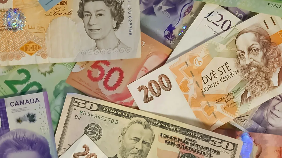 A collection of banknotes from various countries, including the United States, Canada, and the United Kingdom, featuring denominations such as $50, $200, and £20.