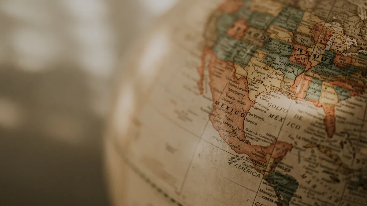 A close-up view of a globe, with the Americas visible, including the United States, Mexico, and Central America.